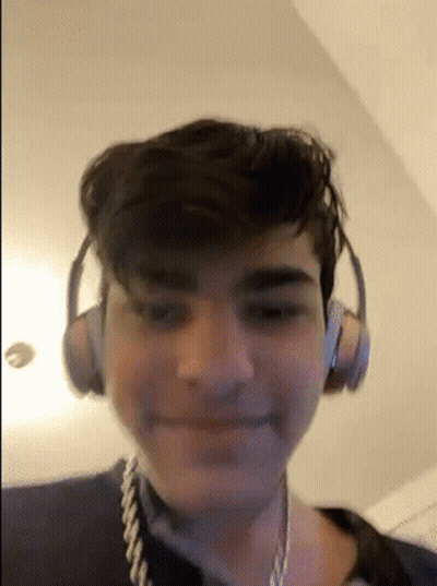 Young Man With Headphones And Rope Around Neck Smiling GIF