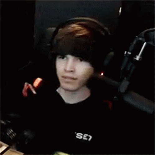Young Man With Headphones At Microphone In Dark Room GIF