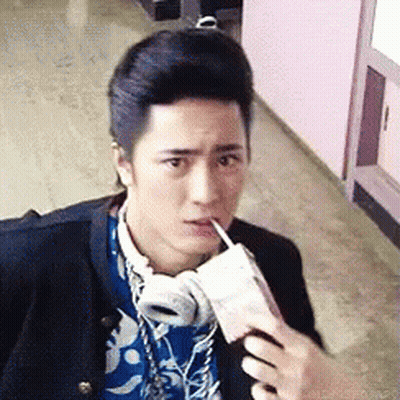Young Man With Headphones Drinking From Cup GIF