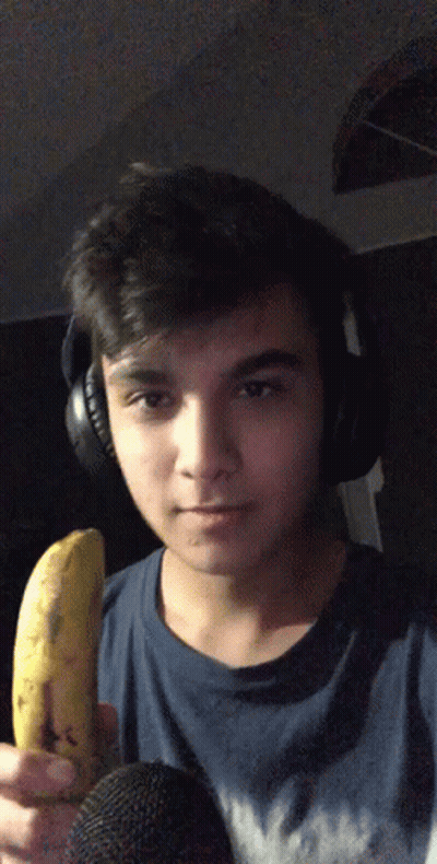 Young Man With Headphones Holding Banana To Microphone GIF
