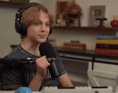 Young Man With Headphones Holding Microphone GIF