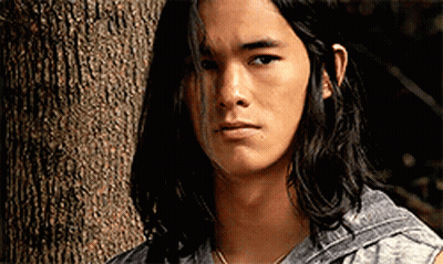 Young Man With Long Black Hair Next To Tree GIF