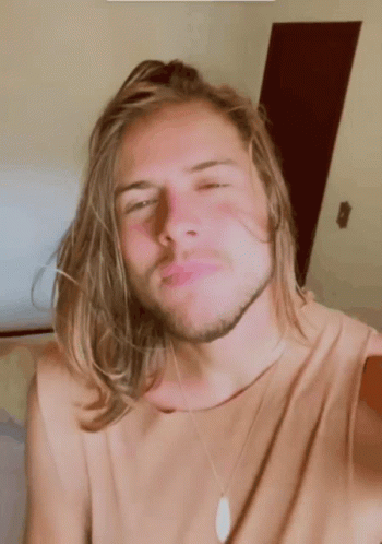 Young Man With Long Blonde Hair And Beard Making Funny Face GIF