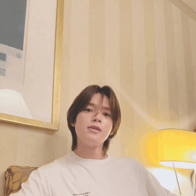Young Man With Long Brown Hair In White Shirt GIF