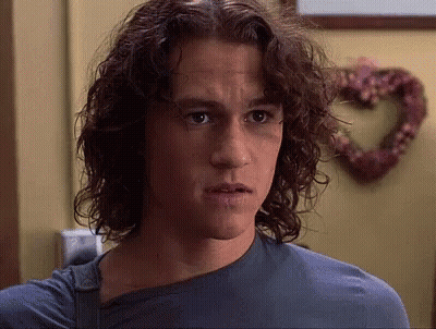 Young Man With Long Curly Hair And Blue Shirt GIF
