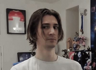 Young Man With Long Hair Standing By Framed Jersey GIF