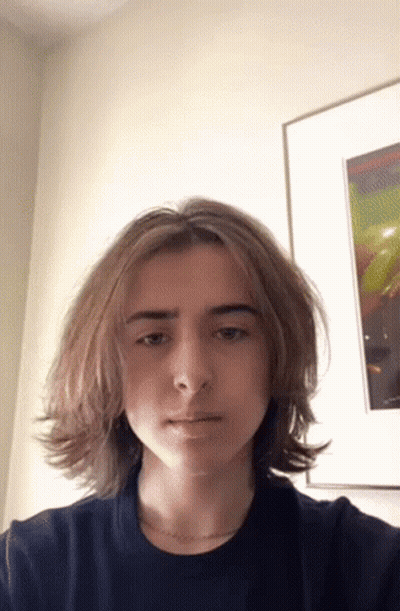 Young Man With Long Hair Taking Selfie GIF