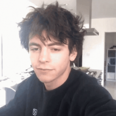 Young Man With Messy Hair In Black Sweatshirt With Letter O GIF