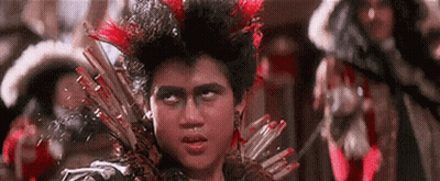 Young Man With Mohawk And Feathers Holding Spear GIF
