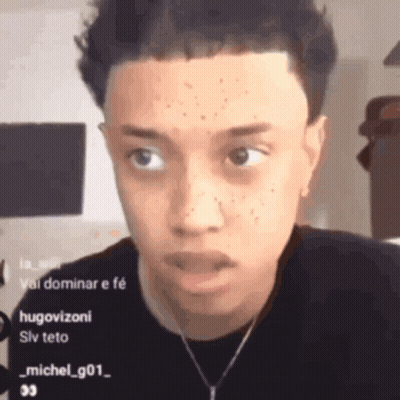 Young Man With Necklace Looking At Camera GIF