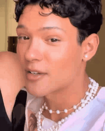 Young Man With Pearl Necklace And Earrings GIF