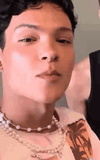 Young Man With Pearl Necklace And Nose Ring GIF