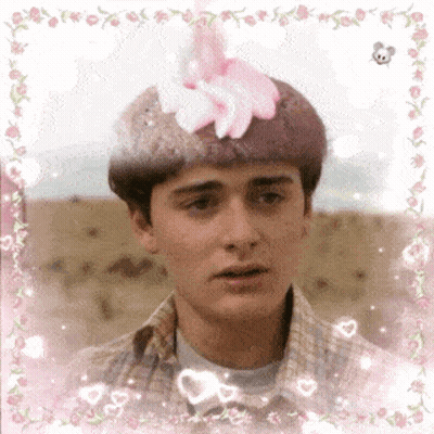 Young Man With Pink Flower On Head GIF