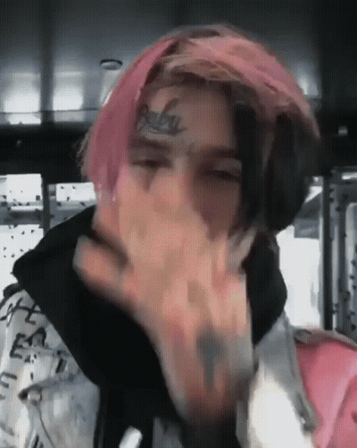 Young Man With Pink Hair And Face Tattoo Covering Mouth GIF
