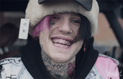 Young Man With Pink Hair And Face Tattoo Smiling GIF