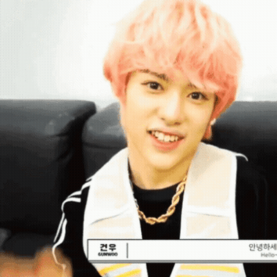 Young Man With Pink Hair Smiling in Black Shirt