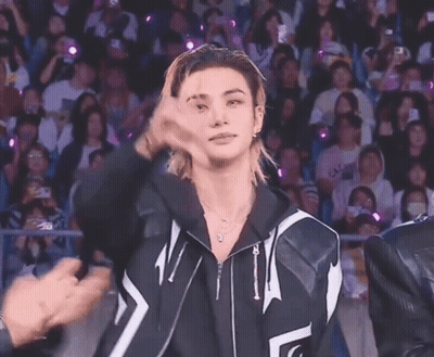 Young Man With Ponytail Giving Peace Sign GIF
