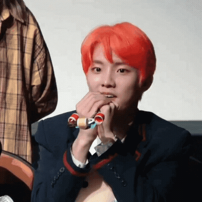 Young Man With Red Hair Holding Toy GIF