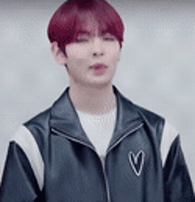 Young Man With Red Hair In Black Jacket With Heart GIF