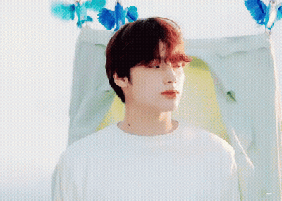 Young Man With Red Hair In Front Of Tent With Blue Butterflies GIF