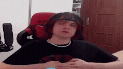 Young Man With Red Hair Sitting In Red Chair GIF