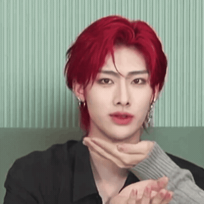 Young Man With Red Hair Sitting On Couch Hands On Neck GIF