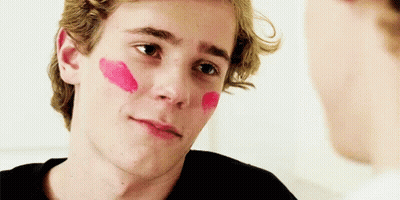 Young Man With Red Lipstick Looking At Another Man GIF