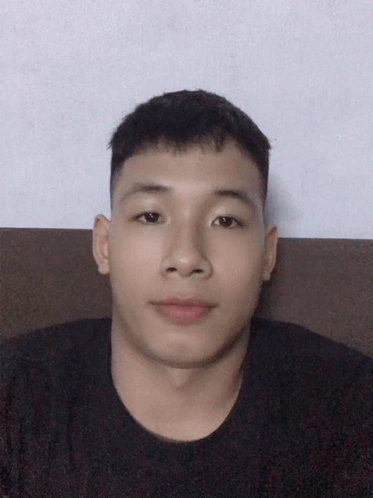 Young Man With Short Hair Sitting On Couch GIF