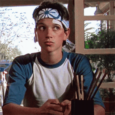 Young Man With Star Headband Sitting GIF