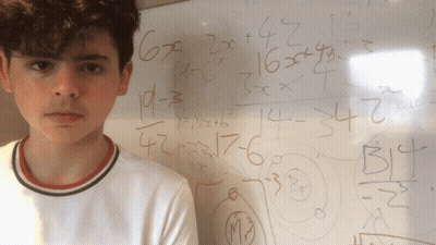Young Man With White Board And Math Problems GIF