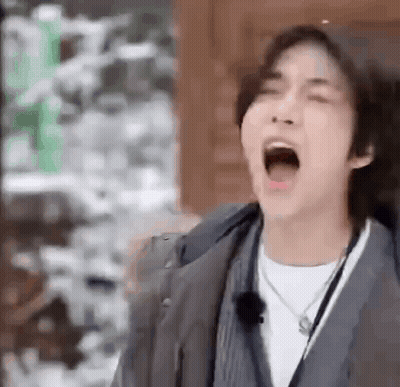 Young Man Yawns In Jacket Necklace GIF
