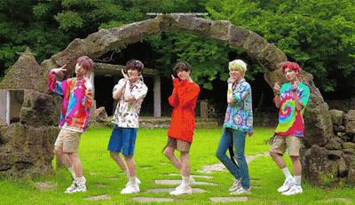 Young Men By Stone Archway In Field GIF