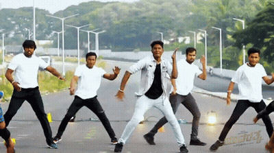 Young Men Dancing In Front Of Aditya Sign GIF