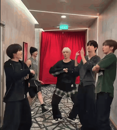 Young Men Dancing In Hallway Under Exit Sign GIF