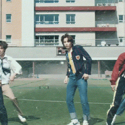 Young Men Dancing On Soccer Field In Front Of Building GIF