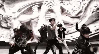 Young Men Dancing On Stage In Front Of Statue GIF