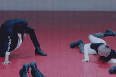 Young Men Doing Handstands On Red Floor Saying Haha GIF