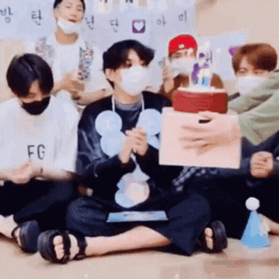 Young Men In Face Masks Holding Birthday Cake GIF