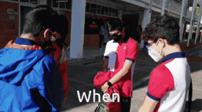Young Men In Face Masks Standing In Front Of Building Saying When GIF