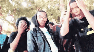 Young Men In Line One With Glasses And Hoodie GIF