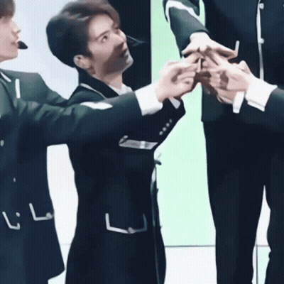 Young Men In Suits Standing Together GIF