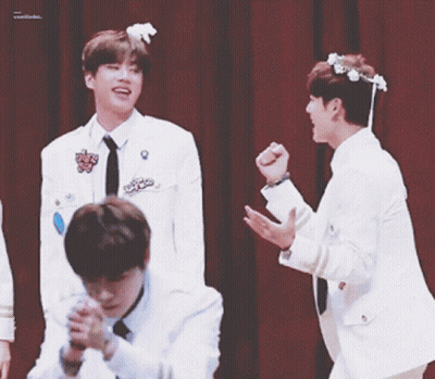 Young Men In White Jackets Waving Hands GIF