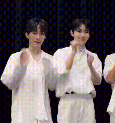 Young Men In White Shirts Raising Hands On Stage GIF