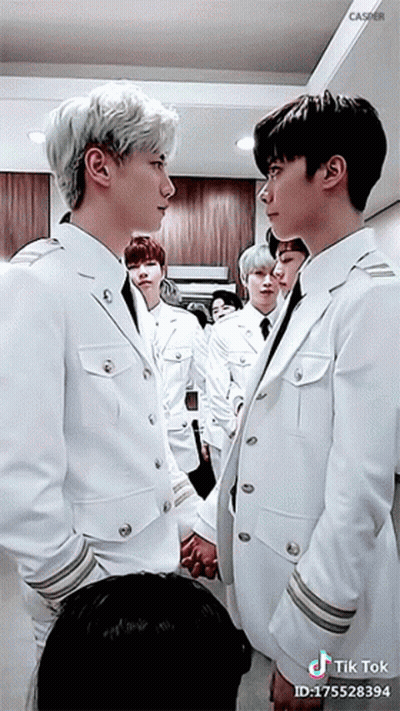 Young Men In White Suits Holding Hands GIF