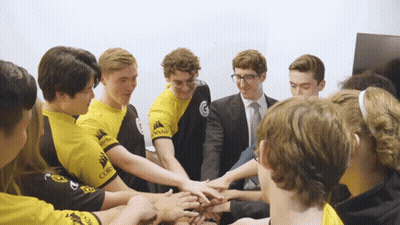 Young Men In Yellow Corsair Shirts Putting Hands Together GIF
