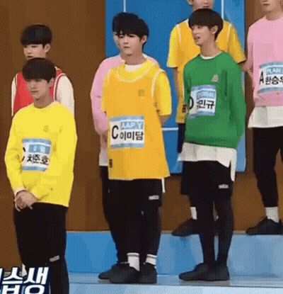 Young Men In Yellow Shirts And Green Sweatshirts On Stage GIF