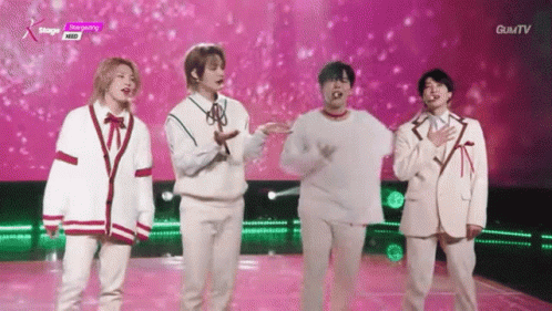 Young Men on Stage With Hands in Air