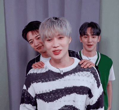 Young Men Posing One In Striped Sweater GIF