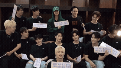 Young Men Posing With Sign Saying A GIF