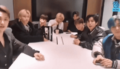 Young Men Sitting Around Conference Table GIF